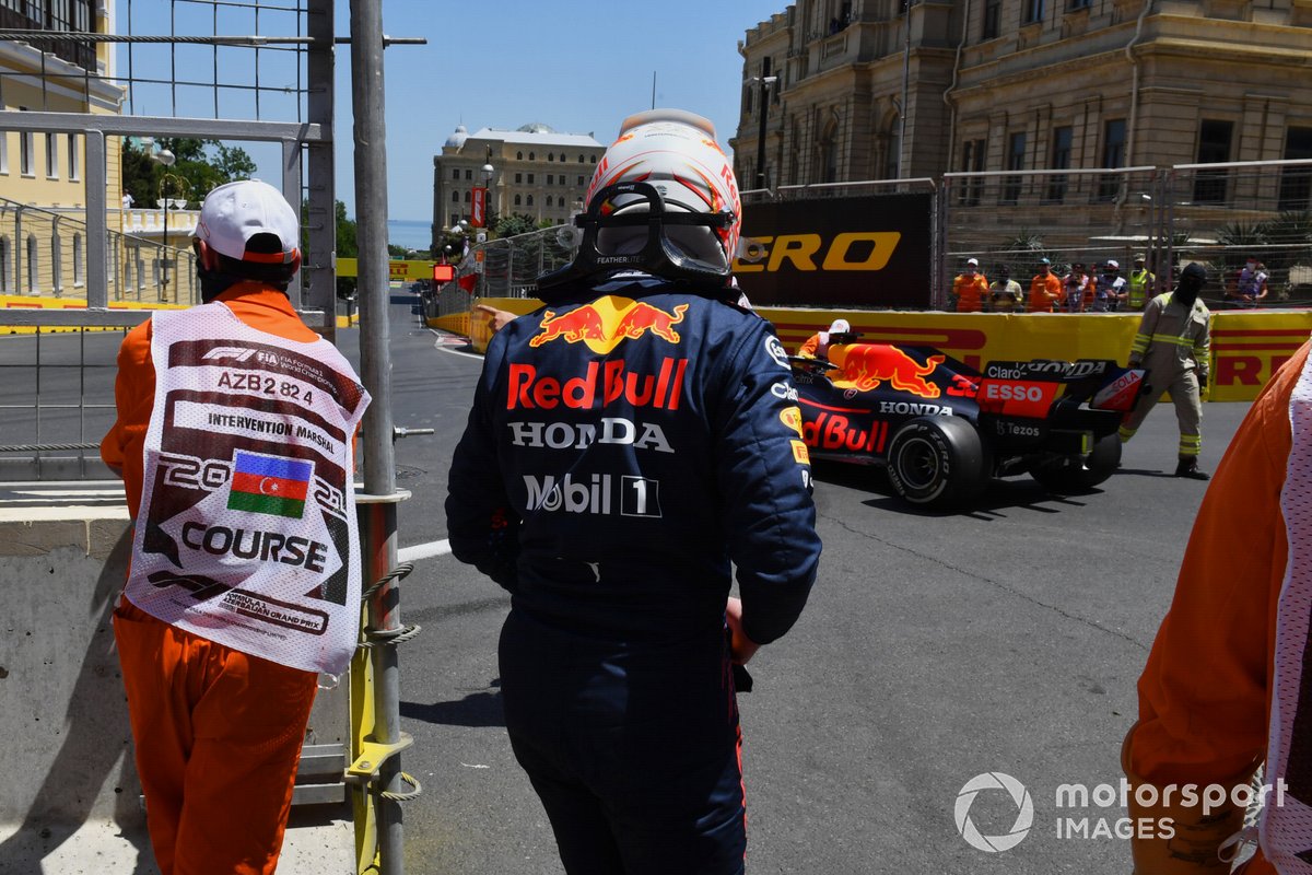 Marshals assist Max Verstappen, Red Bull Racing RB16B, after his crash in FP3
